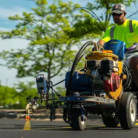 PLM Paving employee on a striping machine