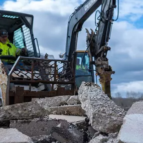 PLM Paving employee in an excavator