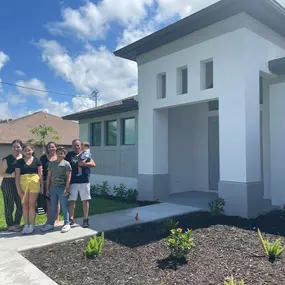 Happy Customers Celebrating Outside Their South Florida Home After Closing with 1st Florida Mortgage Lending