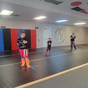 Youth martial arts class where kids build confidence, coordination, and discipline through fun, structured training that blends kickboxing and Jiu-Jitsu fundamentals in a safe, supportive environment.