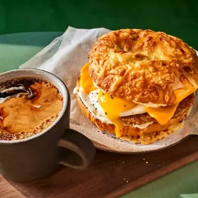 Sausage Over Easy Egg Asiago Sandwich with a hot coffee from Panera