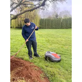 A man uses a lawn mower to trim the grass, emphasizing the importance of regular lawn care maintenance for a healthy lawn.
#lawncare #roboticmowing