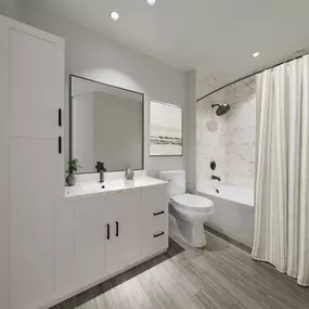 Baths with hardwood-style flooring and tile surrounds at Camden South Charlotte in Charlotte, NC