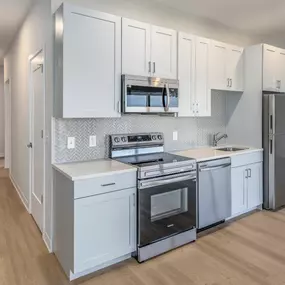 A kitchen with white cabinets and stainless steel appliances.