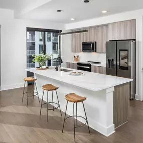 Modern kitchen with an oversized island, sleek cabinetry, and stainless steel appliances.