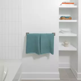 Bathroom with built-in shelving and sleek finishes.