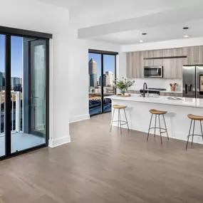 Spacious open-concept kitchen and living area with skyline views.