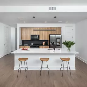 Modern kitchen with warm wood cabinetry and a spacious island.