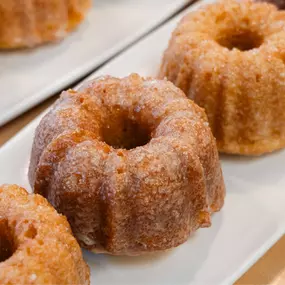 Mini Orange Bundt Cake
Our mini orange bundt cakes are a true artisan delight, made from a signature recipe in collaboration with a renowned chef. Crafted with locally sourced ingredients, they deliver a moist, citrusy flavor perfect for any occasion.