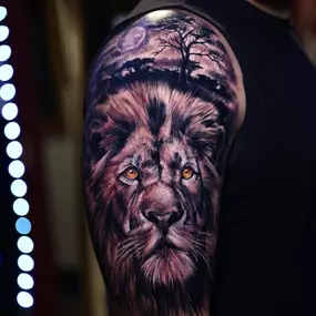 Custom lion tattoo by Brandon Sontag showcases his signature painterly realism style.