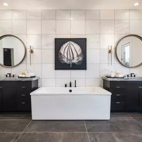 Spa-like primary bathrooms with huge walk-in showers, freestanding soaking tubs, and walk-in closets