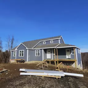 blue house on a hill under construction