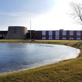 Outside of Tech Credit Union in Crown Point, In. A pond is in front of the building.