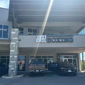 The exterior of the Jabz Boxing - Leon Springs location, featuring modern architecture and the bold 