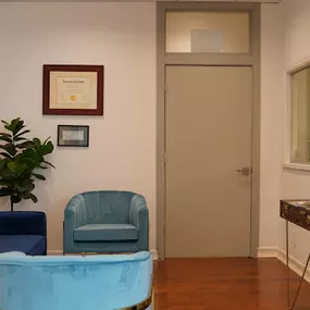 blue and a green chair with red shiny floor