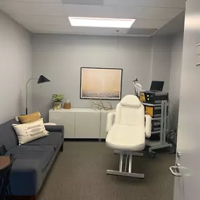 white reclining chair and a gray sofa with white pillow on a well lit room