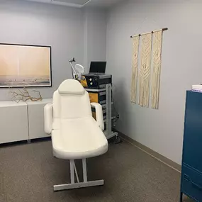 white chair with cabinets in a well lit room