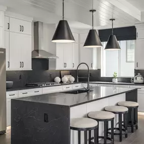 Open kitchen with modern fixtures and stainless steel appliances, found in new construction homes at Salem Foothills in Salem, UT