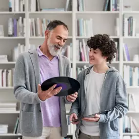 man and child shopping for record