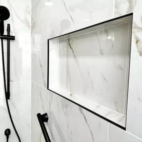 This shower was transformed with a sleek and modern renovation, featuring elegant marble-look tiles and a stylish built-in niche with black trim. The matte black fixtures add a sophisticated contrast, blending functionality with high-end design. As a trusted bathroom remodeling contractor, Ledezma Remodeling ensures every detail enhances aesthetics and convenience.