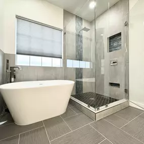 Here's one of our finished bathroom remodeling projects at Ledezma Remodeling—a modern bathroom featuring a sleek freestanding tub and a custom shower design. Visit our website to learn more about our bathroom remodeling services.