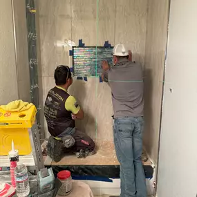 Our team at Ledezma Remodeling meticulously installs intricate tilework during a bathroom remodeling project. We take pride in delivering precision and craftsmanship to every renovation.