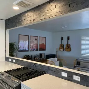 This home remodeling project by Ledezma Remodeling combines functionality with visual impact. The textured stone finish adds depth and sophistication, while the open layout keeps the energy flowing from kitchen to living space. Imagine what we could create together. Your dream space is just a conversation away.