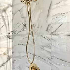 Ledezma Remodeling brought luxury and elegance to this shower remodeling project with striking marble-look tile and a stylish brushed-gold shower fixture. The combination of high-end finishes and expert craftsmanship turns any bathroom renovation into a spa-like retreat. This design adds timeless beauty while enhancing daily comfort.