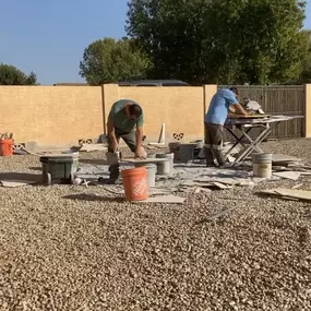 This behind-the-scenes photo captures the skilled team from Ledezma Remodeling hard at work, cutting and preparing tile for an upcoming bathroom renovation project. Set against a bright, clear sky, the image highlights the craftsmanship and hands-on dedication that goes into every bathroom remodeling and shower renovation the company completes. It's a testament to the precision and care that Ledezma Remodeling brings to transforming spaces.