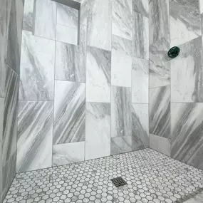 This shower remodel by Ledezma Remodeling is all about style meeting function. The bold veining in the tile and that eye-catching hexagon floor pattern bring a touch of luxury to your daily routine. Proof that shower remodeling doesn’t have to be boring.