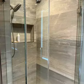 Simplicity meets sophistication in this stunning shower remodeling transformation by Ledezma Remodeling. From the warm, earthy tones of the tile to the crystal-clear glass doors, every element was designed to transform the daily routine into a relaxing escape.