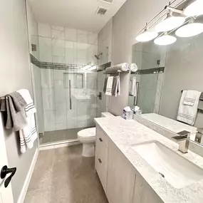 Ledezma Remodeling delivered a crisp, modern finish to this guest bathroom with clean lines, neutral tones, and elegant tile work. From the frameless glass shower to the sleek vanity, every detail is thoughtfully done to enhance comfort and function. If you're looking for a bathroom remodeling contractor who brings care and craftsmanship to every project, this space says it all.