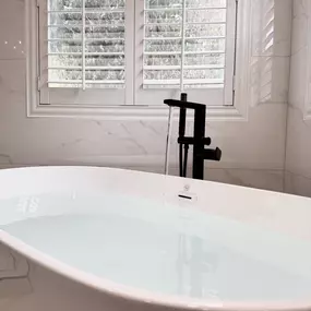 Step into pure relaxation with this stunning bathtub remodel by Ledezma Remodeling. From the sleek freestanding tub to the modern matte black fixtures and elegant tilework, every detail invites calm and comfort.  Every element is thoughtfully designed to create a peaceful, spa-like atmosphere.