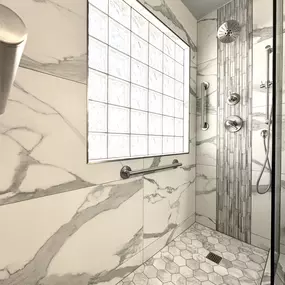 This bathroom renovation by Ledezma Remodeling blends clean design with everyday comfort. The marble-inspired tiles, hexagon flooring, and sleek fixtures create a bright, inviting space that feels calm and thoughtfully crafted. Every detail adds to the feeling of refreshment and ease.