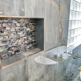 Ledezma Remodeling transforms every bathroom renovation into a stunning work of art, and this design is proof. The elegant blend of shimmering blue-gray tiles with a bold mosaic niche creates a spa‑like retreat that feels both luxurious and inviting. It’s the kind of space that makes you look forward to unwinding every single day.