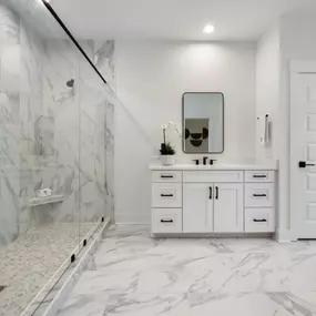 Lavish primary bathrooms with large walk-in showers