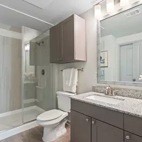 Bathroom with quartz countertops and glass-enclosed shower at Camden Leander apartments in Leander, Tx