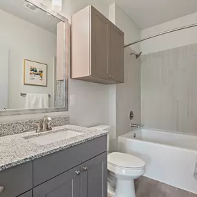 Bathroom with bathtub tile surround and quartz countertops at Camden Leander apartments in Leander, Tx