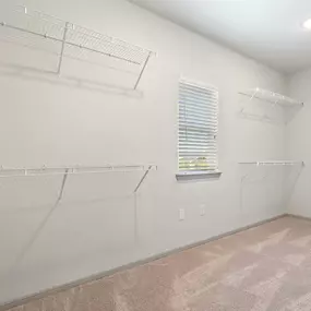 Oversized walk-in closet with wire shelves and window at Camden Leander apartments in Leander, Tx