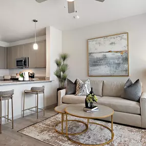 Living room and kitchen with wood-style floors at Camden Leander apartments in Leander, Tx