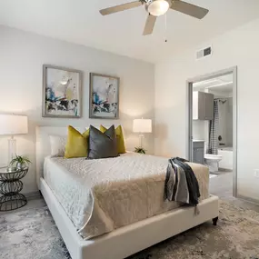 Bedroom with ensuite and wood-style floors at Camden Leander apartments in Leander, Tx