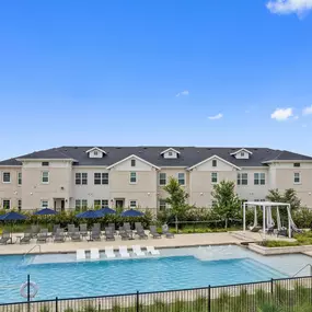 Resort-style pool and sundeck with seating and cabanas at Camden Leander apartments in Leander, Tx