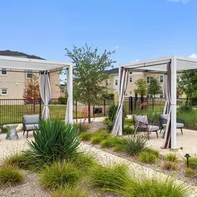 Poolside cabanas with seating at Camden Leander apartments in Leander, Tx