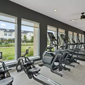 24-hour fitness center with large windows at Camden Leander apartments in Leander, Tx