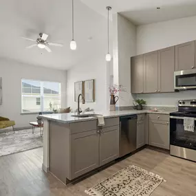 Second-floor kitchen and living room with vaulted ceilings at Camden Leander apartments in Leander, Tx