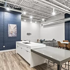 A kitchen with a white countertop and a white refrigerator