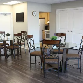 a dining room with a table and chairs