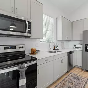 a kitchen with stainless steel appliances and white cabinets