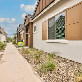 a row of houses with a sidewalk in front of them