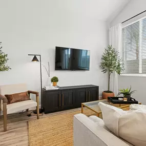 a living room with a couch and a tv on the wall